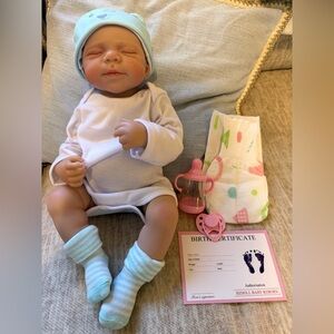 Realistic Baby Doll with Blue Hat and Socks